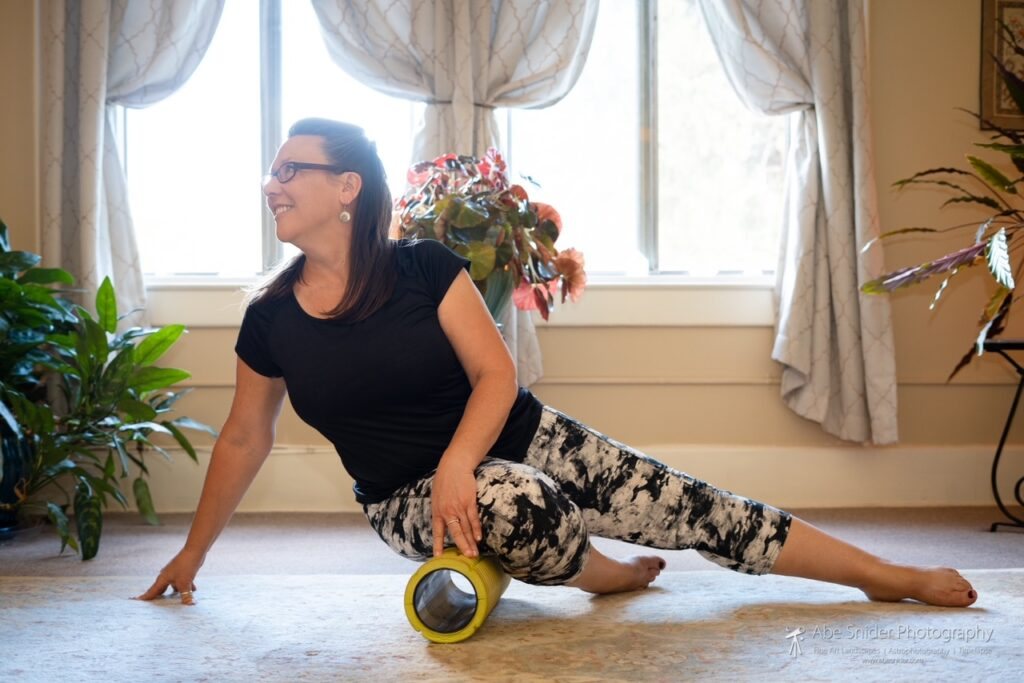 Aileen in a yoga stretch on the studio floor